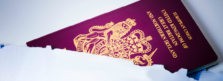 European Union passport poking out of a torn open white envelope