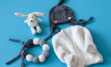 blue and white baby clothes and toys