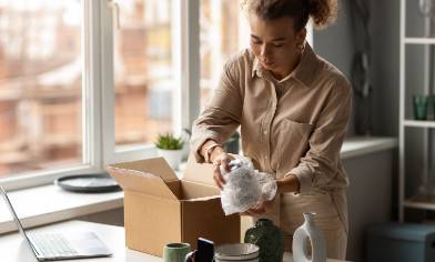lady packing an item into delivery box