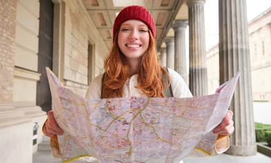 lady holding a map and smiling