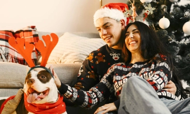 Couple and dog in christmas jumpers