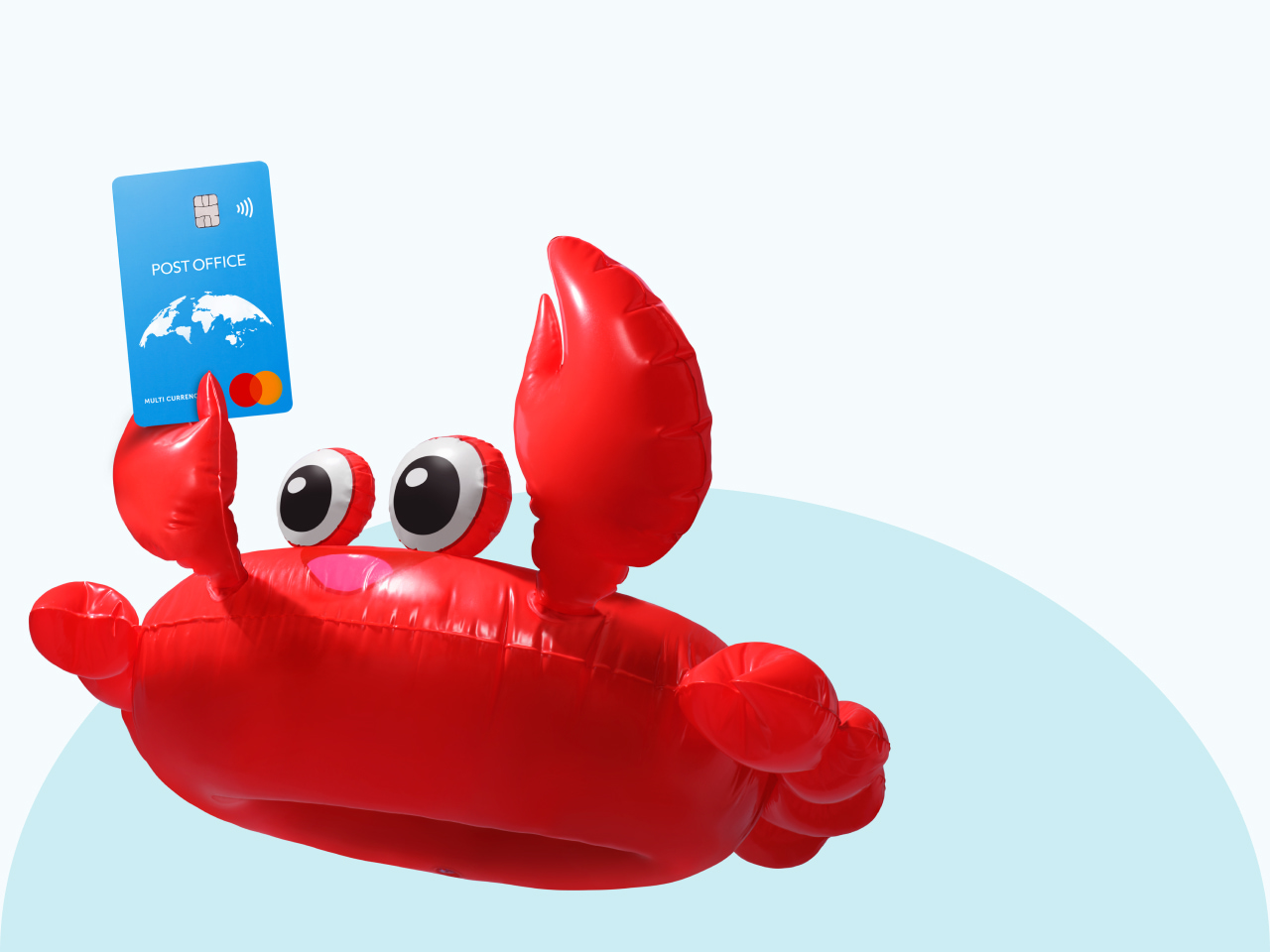 a giant red crab lilo holding a Post Office travel money card aloft