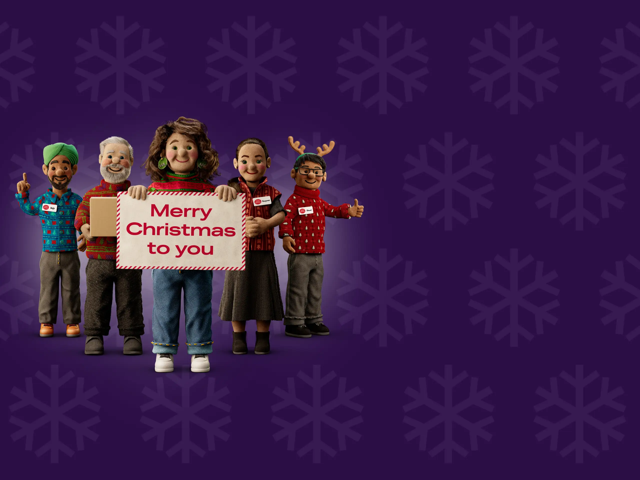 a group of Post Office Christmas helpers holding up a sign that says Merry Christmas to you