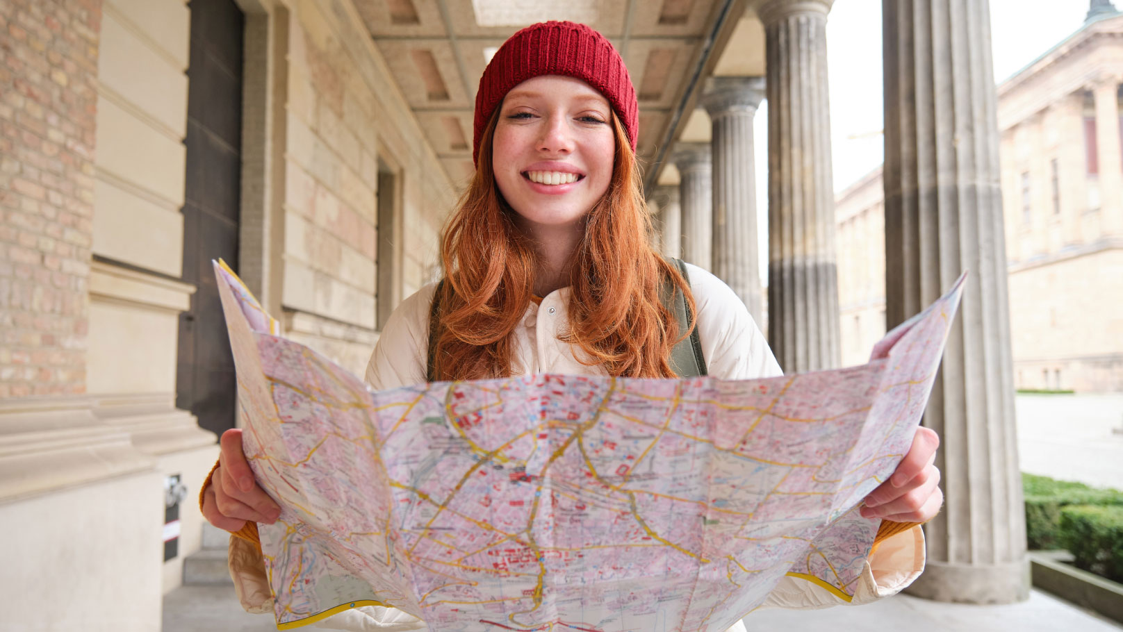 lady holding a map and smiling