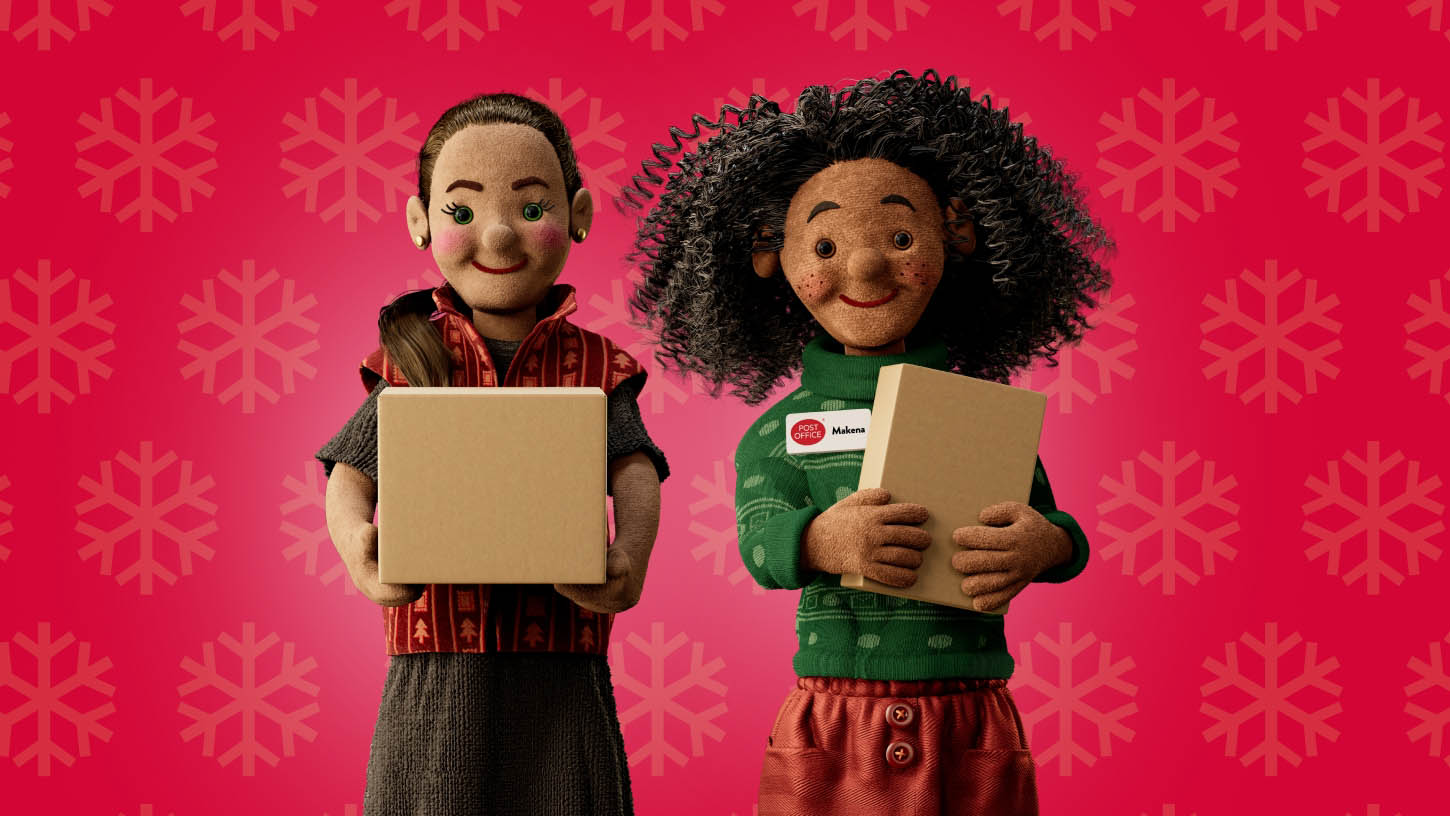 a post office christmas helper and a customer carrying parcels