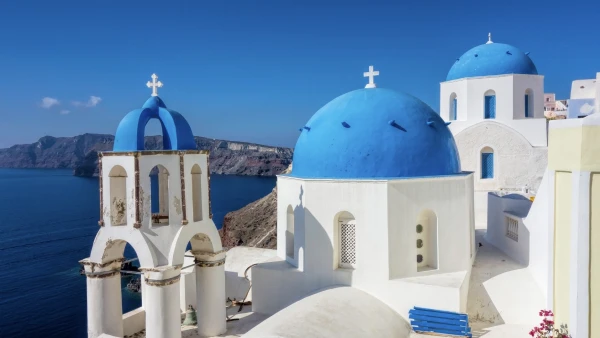 blue domed Greek church overlooking the ocean