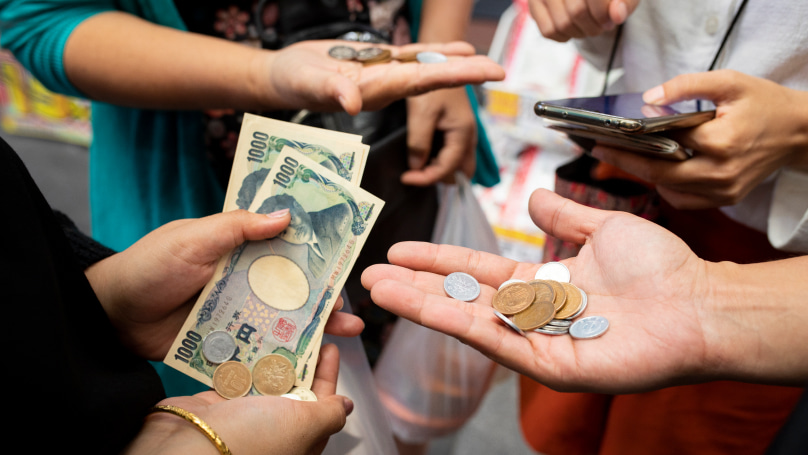 People holding various currencies