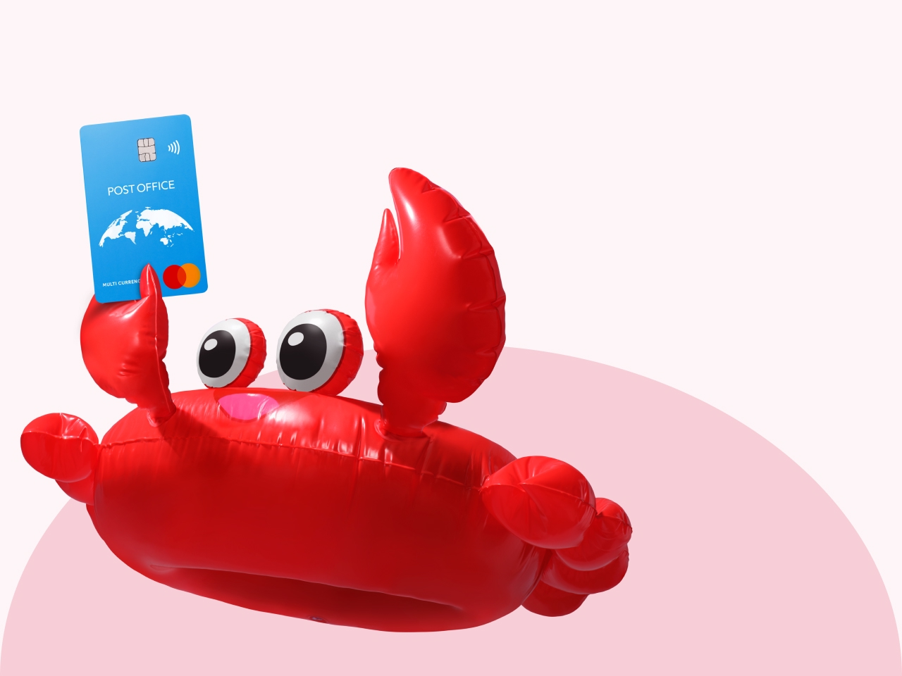 a giant red crab lilo holding a Post Office travel money card aloft